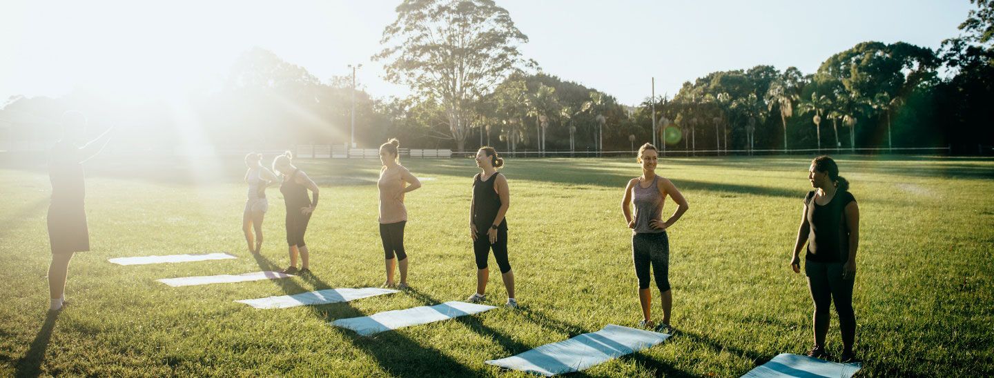 Group exercising on grass