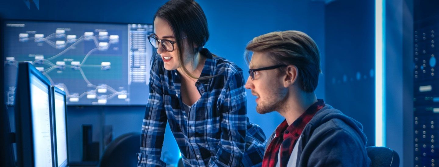 Cybersecurity students working computer