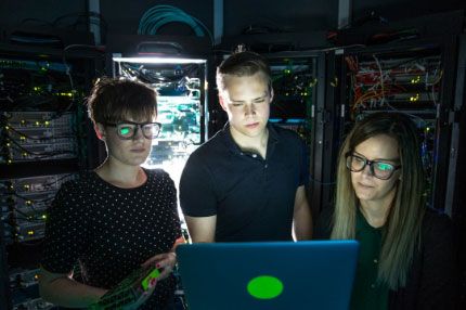 Cybersecurity students working computer