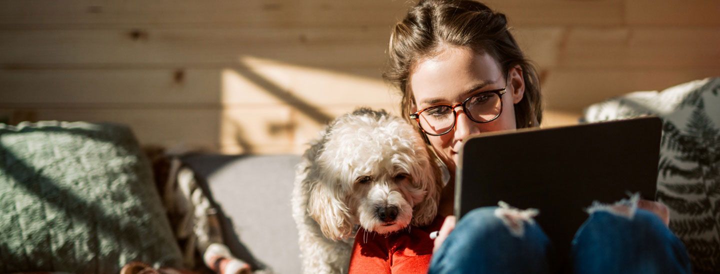 Female and dog looking at digital pad