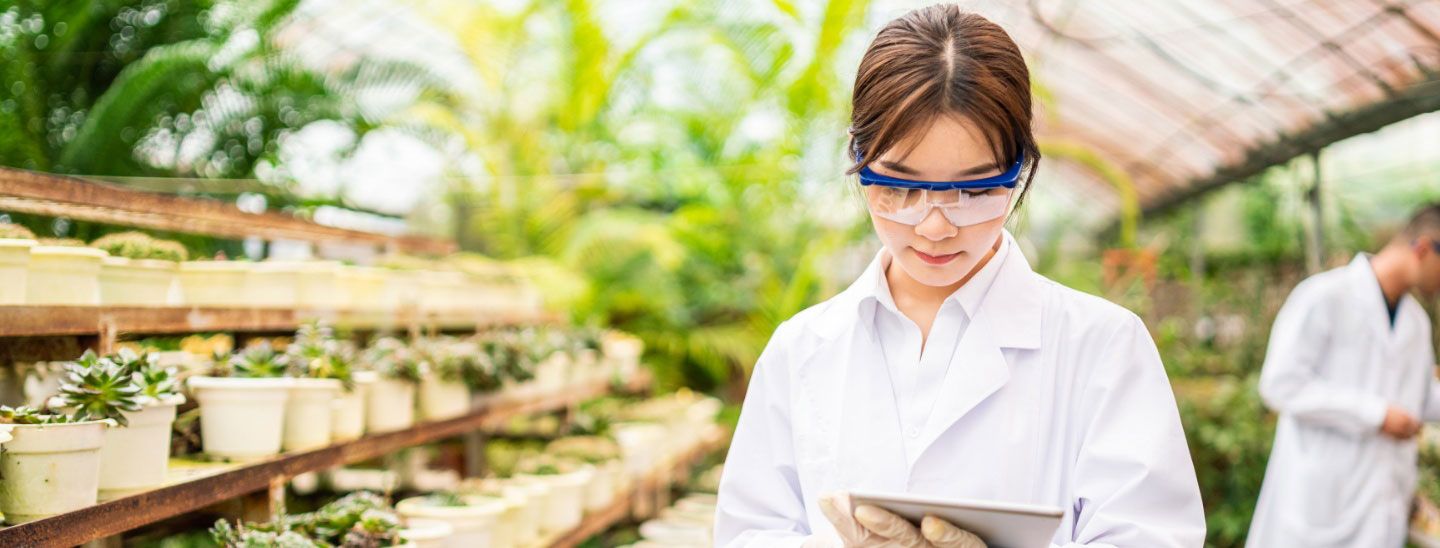 Female Bioscientist working plants