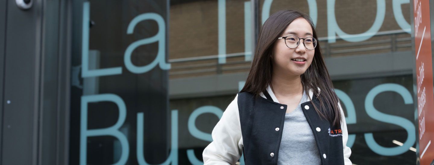 Female student outside building window