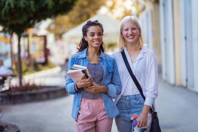 Female students standing and smiling