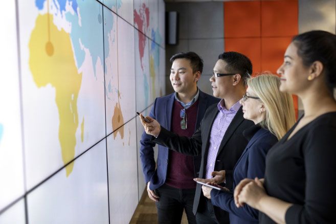 Group looking at digital screen of map