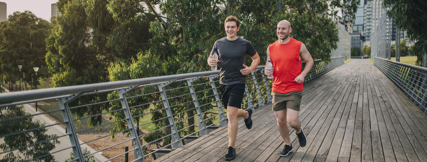 Males running over bridge