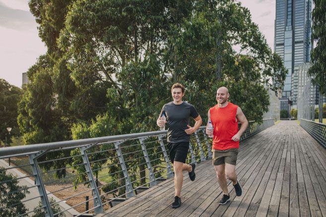 Males running over bridge