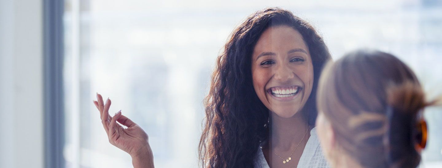 Mature female smiling with hand gesture