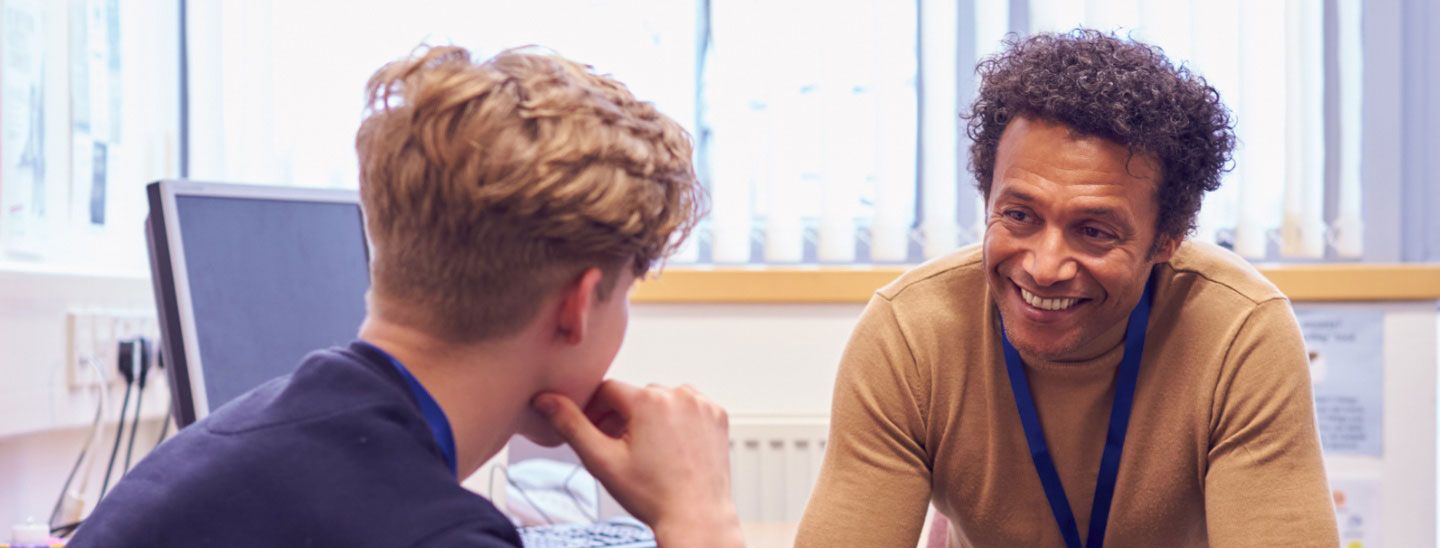 Teacher discussing with student