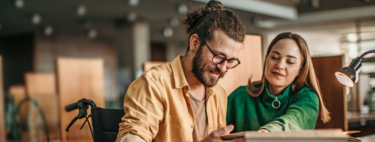 Teacher supporting student in wheelchair