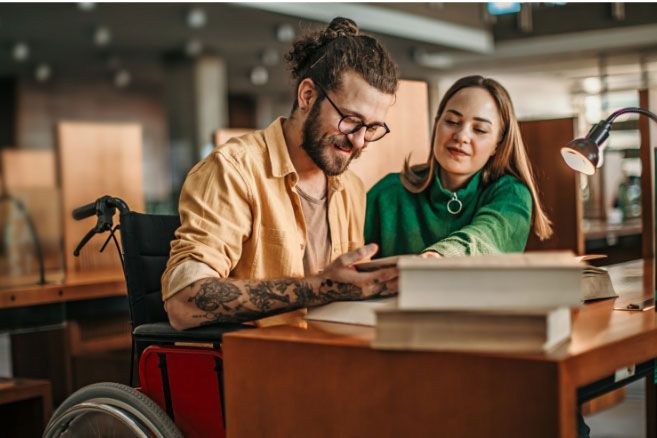 Teacher supporting student in wheelchair