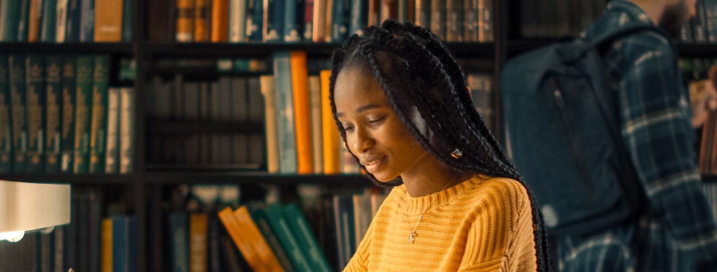 Young female student studying library